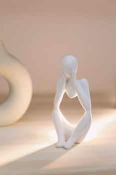 White gypsum decorative figure against beige background with copy space. Concept of template for website or commercial banner.