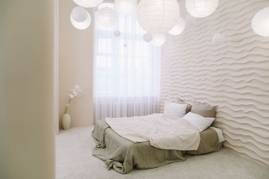White bedroom interior. Stylish interior of contemporary room with comfortable bed.