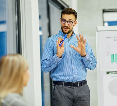 Group of young business people having a meeting or presentation and seminar with whiteboard in the office. Portrait of a young business man