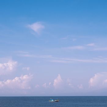 Sea sky cumulus cloud landscape view background. Calm water alone fishing boat. Destination aim progress concept.