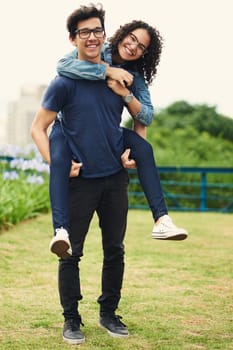 We are young therefor we are playful in love. a teenage girl being piggybacked by her teenage boyfriend outdoors