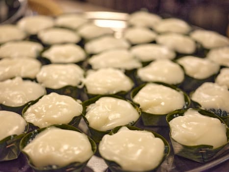 Thai desert ,Famous Thai Pudding with Coconut topping on banana leaf(Tako)