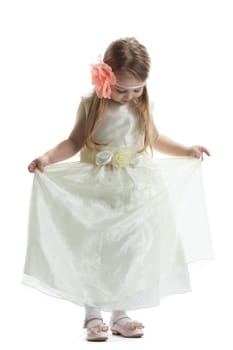 Pretty little girl in beige dress. Isolated on white