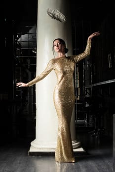 Full length portrait of fashion young woman in gold dress