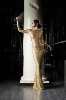Full length portrait of beautiful and fashion woman in gold dress