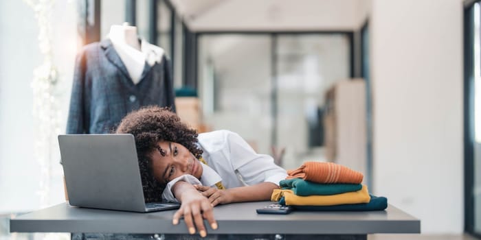 a Asian woman, a stylish fashion designer, thinking of problem to working, tried to new project, while a young businesswoman tries to recover after a long day's work in a clothing store