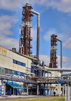 Air pollution by smoke from factory chimneys. The territory of the plant, with pipes and communications.