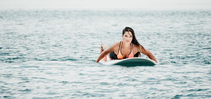 Sea woman sup. Silhouette of happy young woman in pink bikini, surfing on SUP board, confident paddling through water surface. Idyllic sunset. Active lifestyle at sea or river. Slow motion