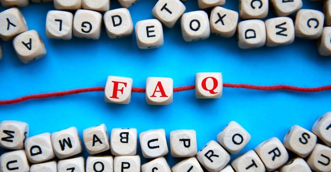 concept of the word FAQ on wooden colorful cubes. frequently asked questions.