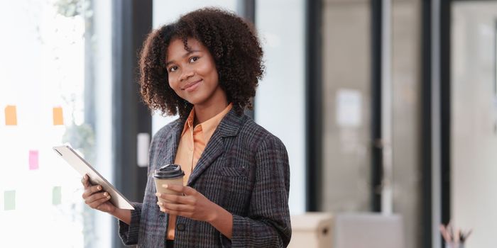 Accountant black woman working on digital tablet and do document, tax, exchange, accounting and Financial advisor concept.