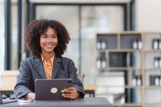 Accountant black woman working on digital tablet and do document, tax, exchange, accounting and Financial advisor concept.