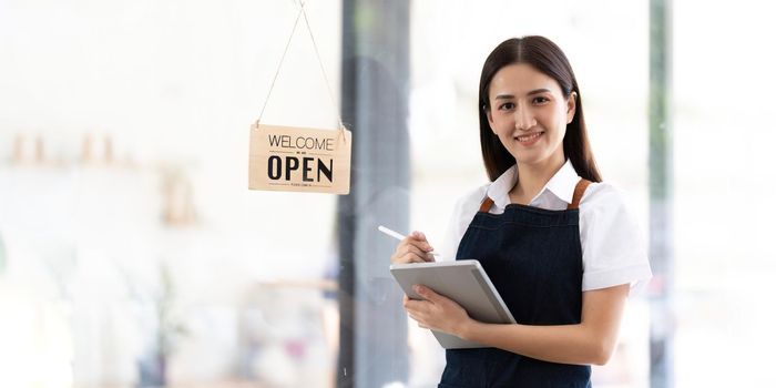 Portrait of a Bright smiling woman prepares to open a shop to welcome customers