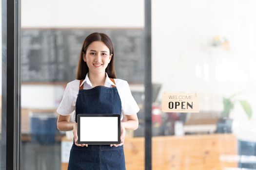 Portrait of a Bright smiling woman prepares to open a shop to welcome customers