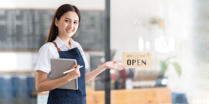 Portrait of a Bright smiling woman prepares to open a shop to welcome customers