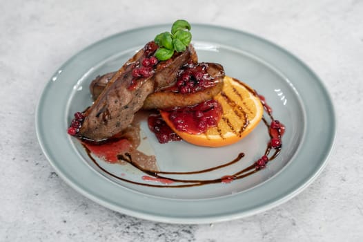 Tasty duck breast with orange and berries