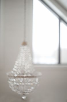 blurred crystal chandelier bokeh out of focus. Glamour background with copy space