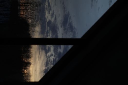 Amazing scenic panoramic sunset sky with colorful clouds through window silhouette. Gradient color. Sky texture, abstract nature background