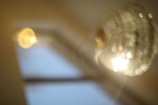 blurred crystal chandelier bokeh out of focus. Glamour background with copy space