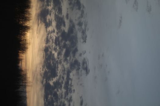 Real amazing panoramic sunrise or sunset sky with colorful clouds. Gradient color. Sky texture, abstract nature background.