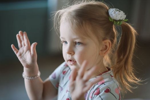 Portrait of a lovely little girl at home. Attractive lovely sweet curious cheerful smart toddler girl.