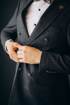 A man in a blue suit zips up his jacket, close-up. Businessman changing clothes.Tonal correction. FASHION, STYLE. High quality photo