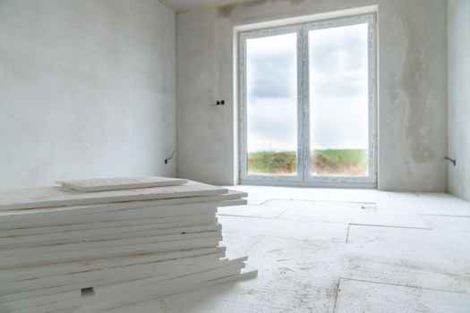 insulation of floors with polystyrene on the construction site.