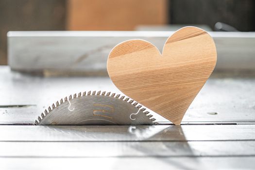 a heart made of wood on a circular in the joinery. I love wood. High quality photo