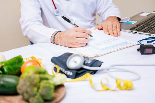 Nutritionist hands taking medical records in the office, Close-up of nutritionist writing on notepad. Concept of nutritionist taking notes on prescription