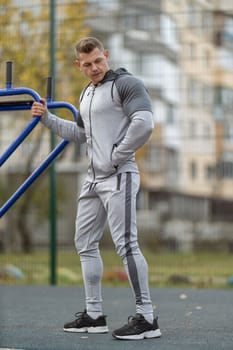 Handsome man goes in for sports on the street. Morning workout outdoors.