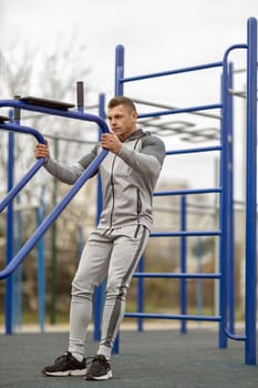 Handsome man goes in for sports on the street. Morning workout outdoors.