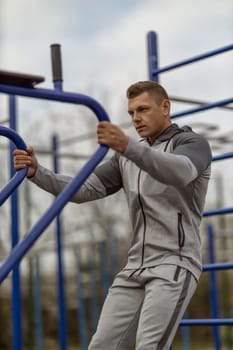 Handsome man goes in for sports on the street. Morning workout outdoors.