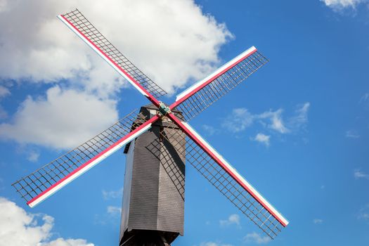 Rustic and iconic wooden windmill in idyllic Bruges public park, Belgium