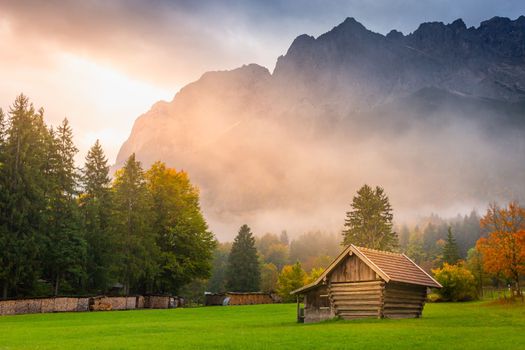 Bavarian alps and rustic farm barns, Garmisch Partenkirchen, Zugspitze massif, Bavaria, Germany