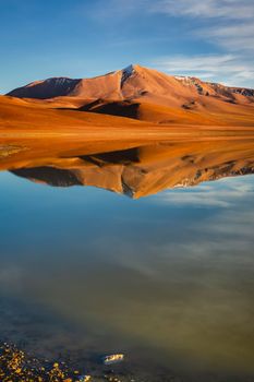 Salt lake Lejia reflection and idyllic volcanic landscape at Sunset, Atacama desert, Chile