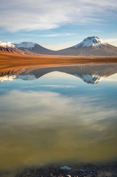 Salt lake Lejia reflection and idyllic volcanic landscape at Sunset, Atacama desert, Chile