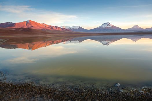 Salt lake Lejia reflection and idyllic volcanic landscape at Sunset, Atacama desert, Chile