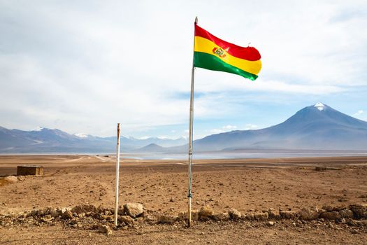 Altiplano volcanic landscape of Potosi Region with Bolivian flag, Bolivia, South America