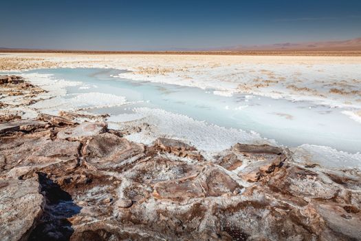 Salt lake reflection and idyllic volcanic landscape at sunrise, Atacama desert, Chile border with Bolivia