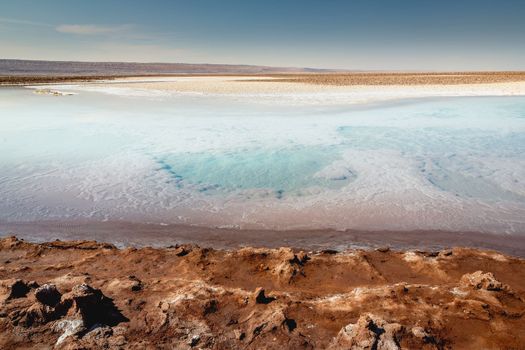 Salt lake reflection and idyllic volcanic landscape at sunrise, Atacama desert, Chile border with Bolivia