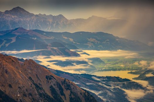 Hohe Tauern mountains and lake from above Grossglockner road at dramatic dawn, Austria