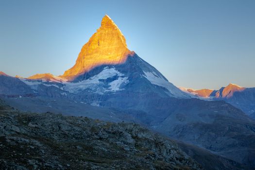 Reflection of the Matterhorn on blue and placid lake at sunrise, Swiss Alps, Zermatt, Switzerland