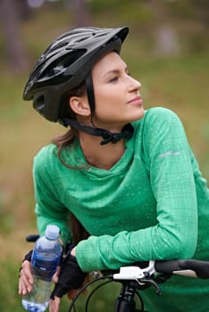Beauty and her bike. an attractive young woman cycling outdoors