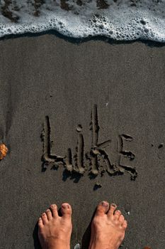 close-up of feet on the sand. bali