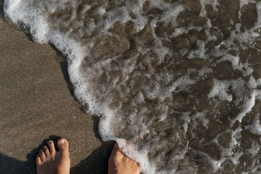 close-up of feet on the sand. bali