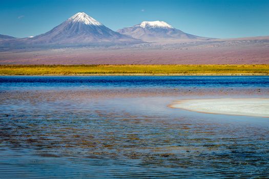 Licancabur and Peaceful reflection lake with dramatic volcanic landscape at Sunset, Atacama Desert, Chile