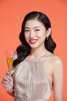 Cheerful attractive woman holding glass with champagne