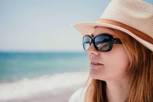 Young woman in red bikini on Beach. Blonde in sunglasses on pebble beach enjoying sun. Happy lady in one piece red swimsuit relaxing and sunbathing by turquoise sea ocean on hot summer day. Close up,