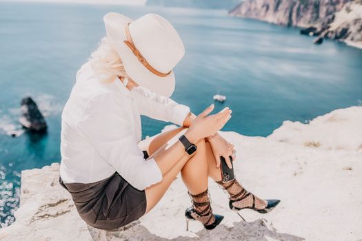 Happy girl doing yoga with laptop working at the beach. beautiful and calm business woman sitting with a laptop in a summer cafe in the lotus position meditating and relaxing. freelance girl remote work beach paradise