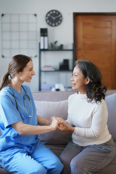 Portrait of a female doctor holding a patient's hand to encourage the fight against disease