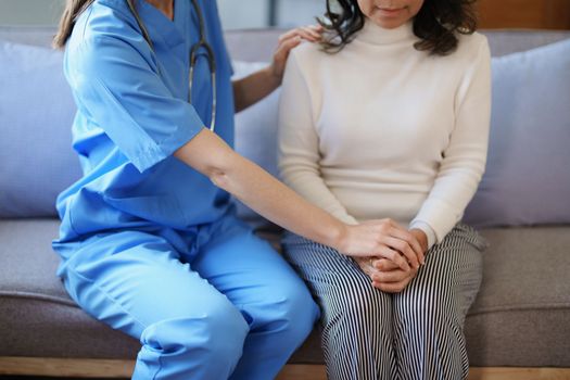 Portrait of a female doctor holding a patient's hand to encourage the fight against disease